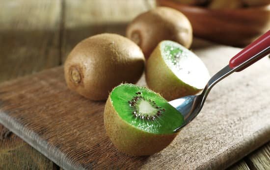 canva scooping out a kiwi with a spoon MAD MRaihDU