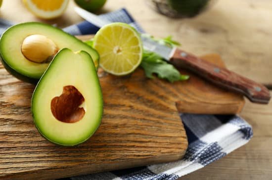 canva sliced avocado and lime on a wooden board MAD