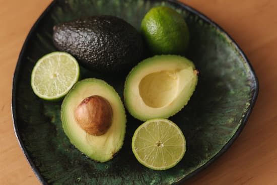 canva sliced avocado and limes on plate MAERFWAofIc