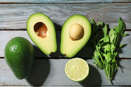canva sliced avocado arugula and lime on a table MAD MXawQbI