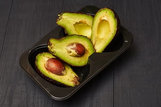 canva sliced avocado in a tray on a black wooden background MAEAp1Qwfyk
