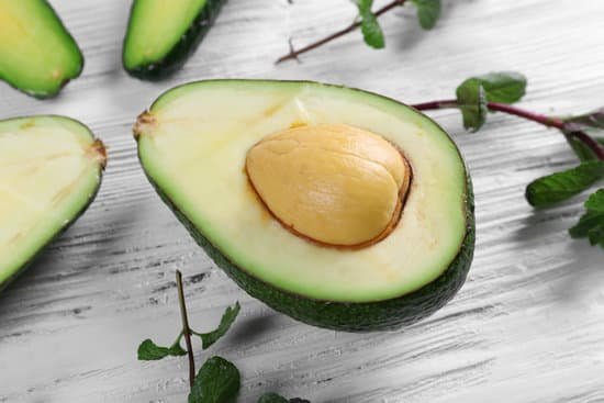 canva sliced avocado on a light wooden background MAD QvcJzXY