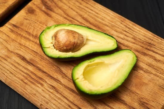 canva sliced avocado on a wooden board MAEEE RGj4k