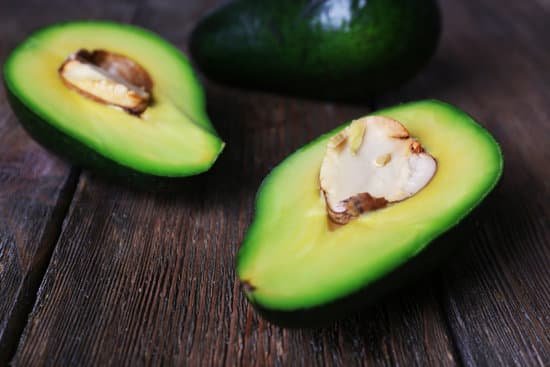 canva sliced avocado on wooden background MAD MGV0ifk