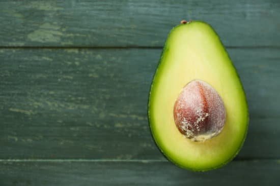 canva sliced avocado on wooden background MAD Ma7BBHU