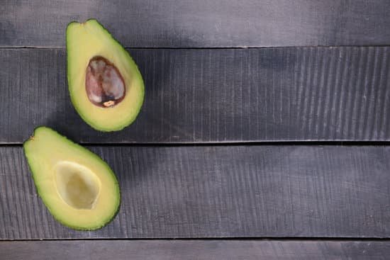 canva sliced avocado on wooden background MAD Qi92E6c