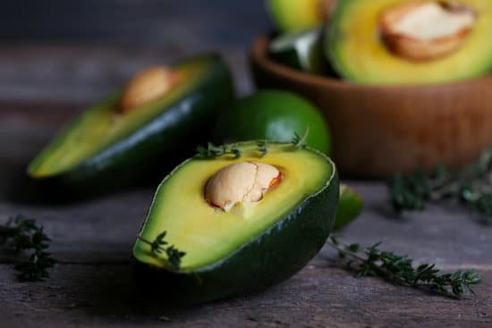 canva sliced avocado with herb in bowl on wooden background MAD MPsVbAc