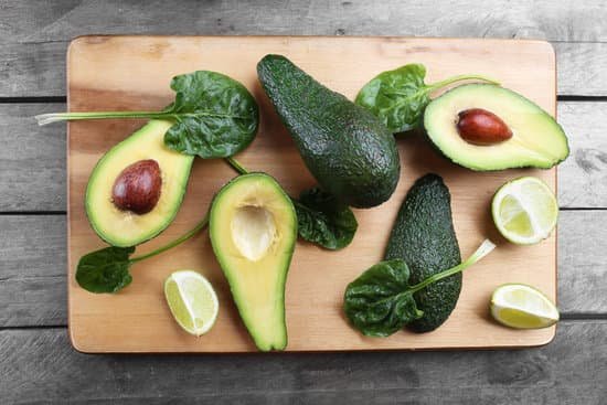 canva sliced avocado with lime and spinach on wooden board MAD QqTO Zo