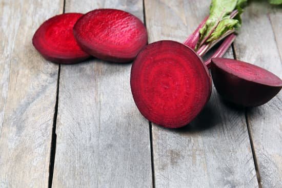 canva sliced beets on wooden table closeup MAD MZKUSUQ