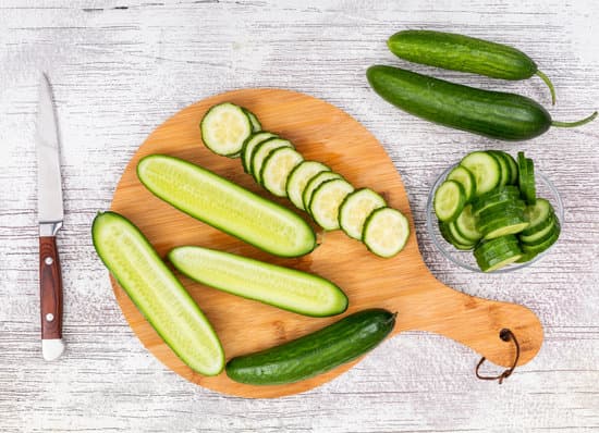 canva sliced cucumber on a cutting board MAD gVkGFXw