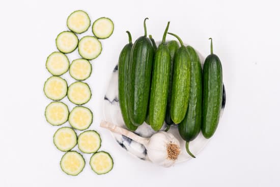 canva sliced cucumbers and garlic on a table MAD gQUbhs4