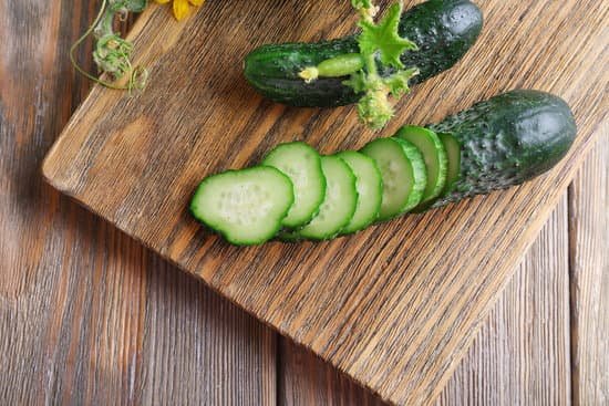 canva sliced cucumbers and kitchen board on wooden background MAD MuvQ03Y