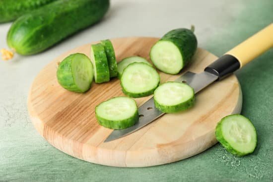 canva sliced cucumbers on a wooden chopping board MAD6rMbUJGA