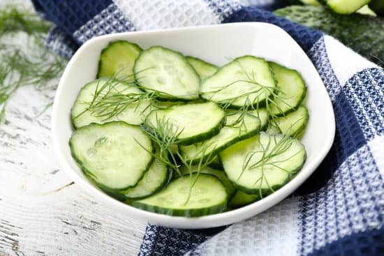canva sliced cucumbers on white plate with blue checked cotton serviette MAD Mk8dkrc