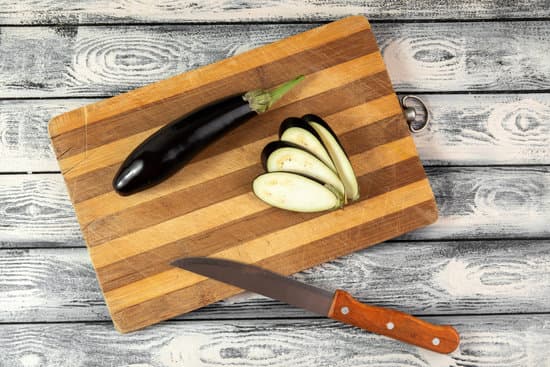 canva sliced eggplants on wooden chopping board MAD70vpMw20