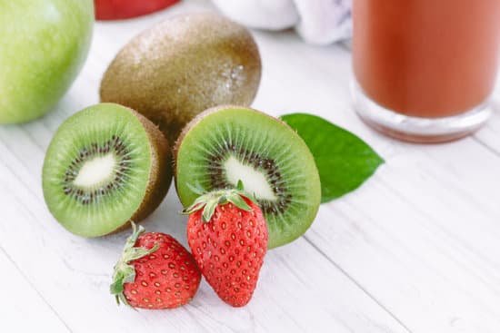 canva sliced kiwi and strawberry on wooden background MAEGnpAtd0o