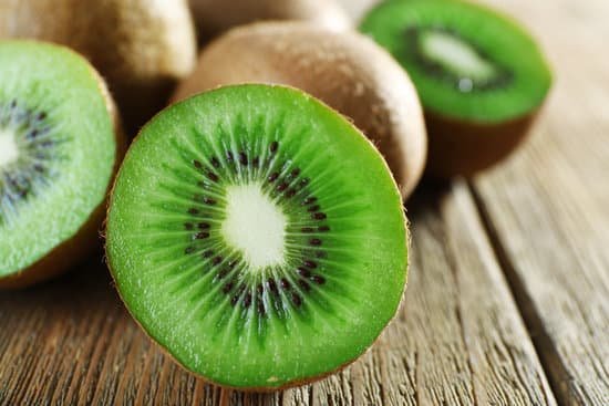 canva sliced kiwi on a wooden table MAD Ma8rw 4