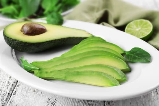 canva slices of fresh avocado on plate closeup MAD QgYj2mE