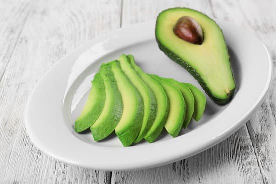 canva slices of fresh avocado on plate closeup MAD QnOH4Ss