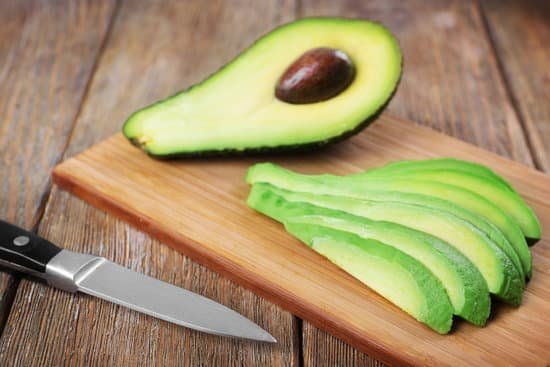 canva slices of fresh avocado on wooden board MAD QuvQvR4