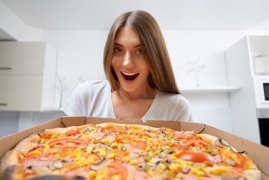 canva smiling woman holding delicious pizza. MAEat0ekQi8