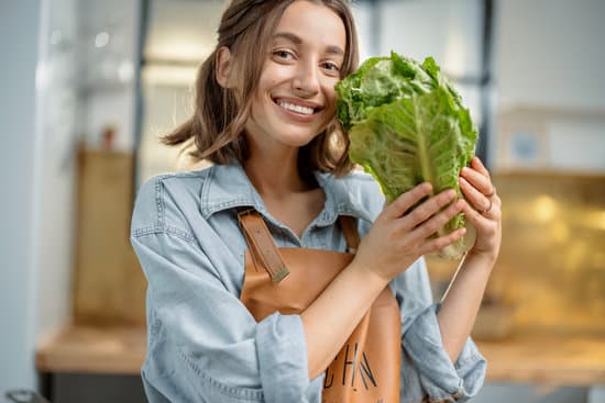 canva smiling woman in apron holding lettuce