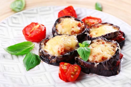 canva stuffed eggplant with tomatoes and cheese on a plate MAD MbRqvuQ