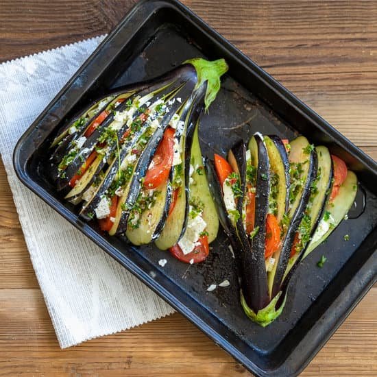 canva stuffed eggplants with vegetables on the baking tray on table MAEF yKG0g