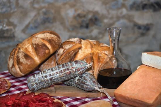 canva table on the farm with salami bread wine and local cheeses MAEqiihNK04