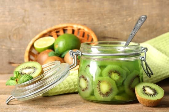 canva tasty kiwi jam in glass jar on wooden background MAD