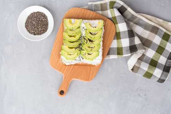canva toast with avocado and chia seeds on wooden board flatlay MAEPSBoegks