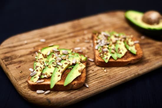 canva toast with sliced avocado and grains on a serving board MAEApwNck00