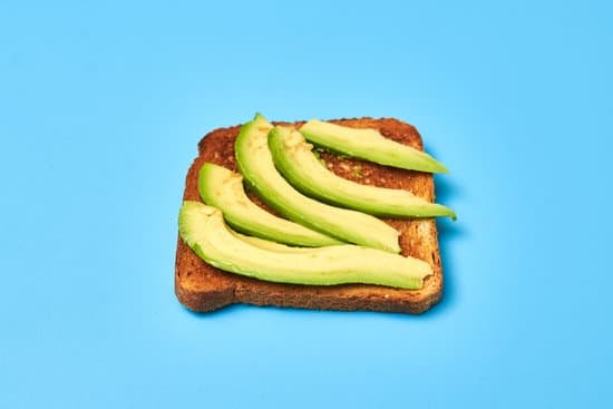 canva toast with sliced avocado on a blue background MAEAp jBQL4