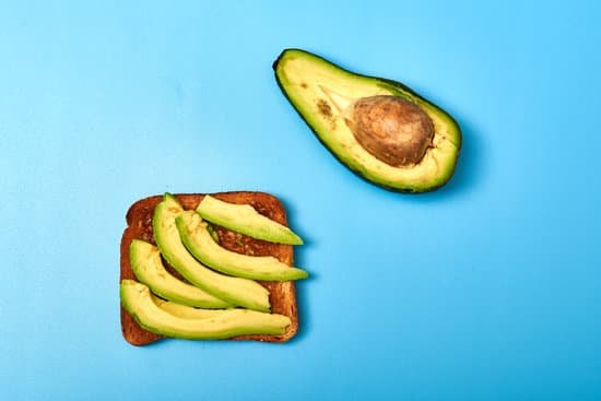 canva toast with sliced avocado on a blue background MAEAp9NZLds