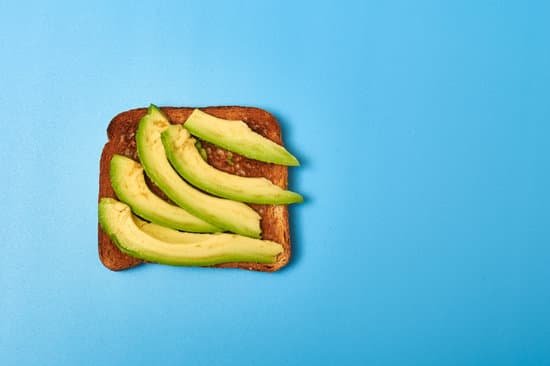 canva toast with sliced avocado on a blue background