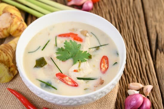 canva tom kha kai in a bowl with kaffir lime leaves lemongrass red o MAD phMZhKw