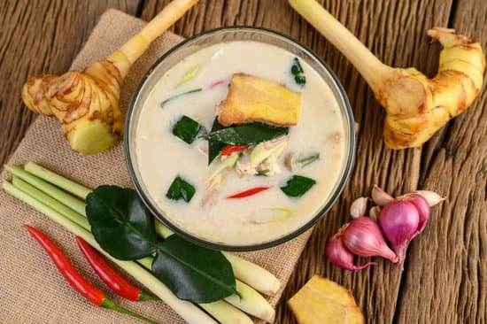 canva tom kha kai in a bowl with kaffir lime leaves lemongrass red o MAD pi kQmM