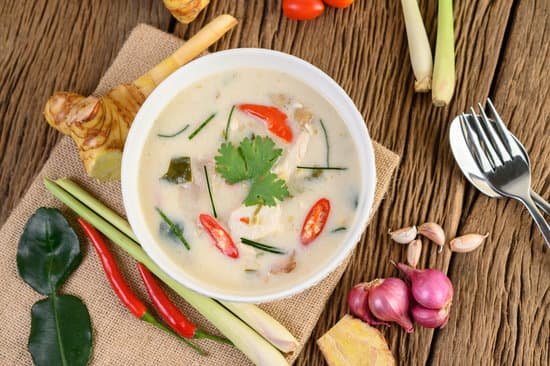 canva tom kha kai in a bowl with kaffir lime leaves lemongrass red o MAD plcBWaI