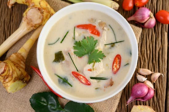 canva tom kha kai in a bowl with kaffir lime leaves lemongrass red o MAD pngRvV0