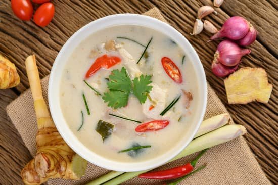 canva tom kha kai in a bowl with kaffir lime leaves lemongrass red o MAD po0OHBM