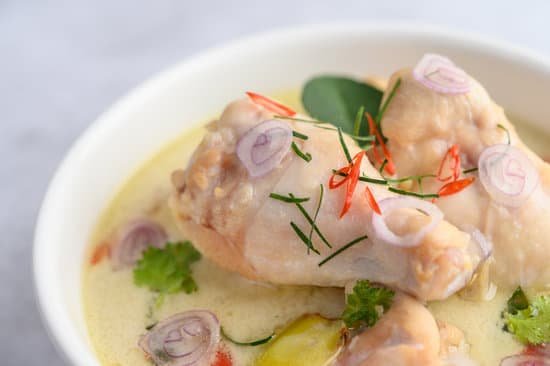 canva tom kha kai in a bowl with kaffir lime leaves lemongrass red o MAD2yJTLUb0