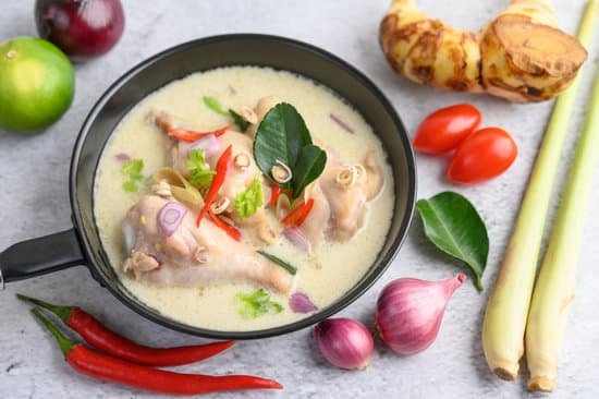 canva tom kha kai in a pan frying with kaffir lime leaves lemongrass MAD pSSvy8o