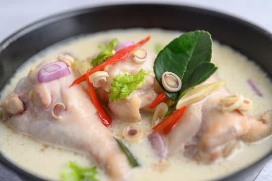 canva tom kha kai in a pan frying with kaffir lime leaves lemongrass MAD pZ NKos