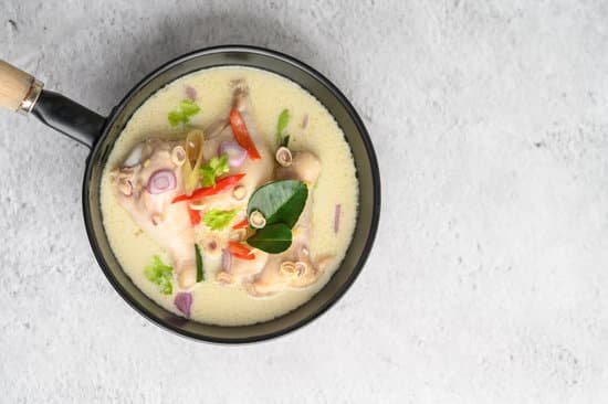 canva tom kha kai in a pan frying with kaffir lime leaves lemongrass MAD2yAA5 bg