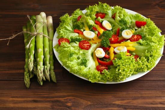 canva vegetable salad in plate with asparagus on wooden table MAD