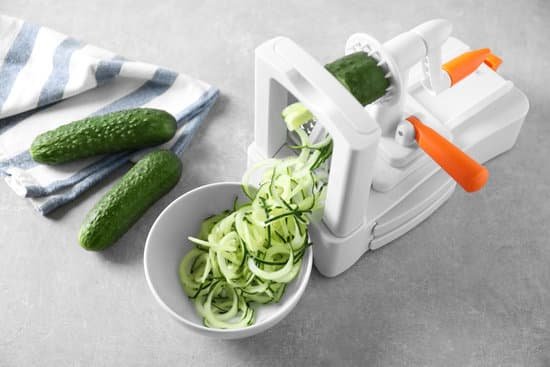 canva vegetable slicer with cucumber on a table MAD9T61rfcg