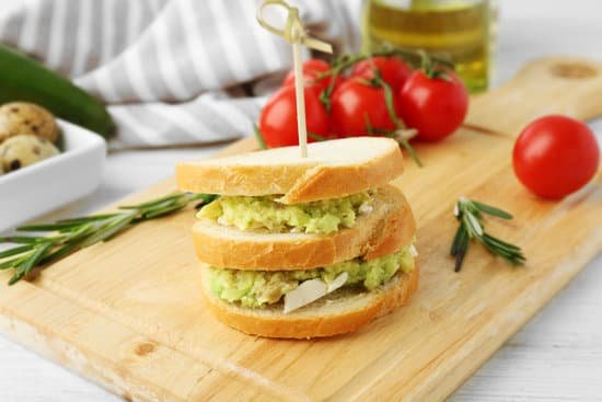 canva vegetarian avocado sandwich on a wooden board MAD QtAzeHs