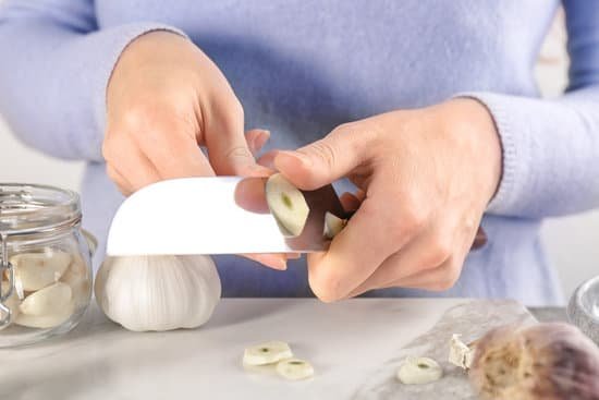 canva woman cutting garlic at table MAD76qETu1g