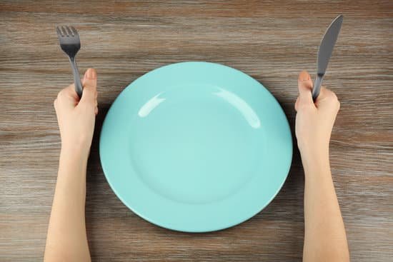 canva woman holding fork and knife near empty plate MAEsBI4kHXA