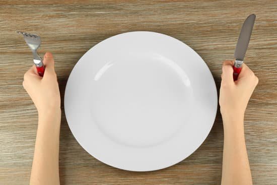 canva woman holding fork and knife near empty plate top view MAEsBPSCTdM